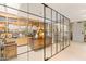 Home office with a wall of books, built in shelving, and a modern glass partition at 5905 N Echo Canyon Ln, Phoenix, AZ 85018