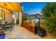 Outdoor kitchen with built-in grill, dining area with mountain views, and lush landscaping at 5905 N Echo Canyon Ln, Phoenix, AZ 85018