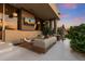 Stylish outdoor patio with comfortable seating, outdoor television, shade covering, and inviting ambiance at 5905 N Echo Canyon Ln, Phoenix, AZ 85018