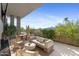 Expansive outdoor patio with comfortable wicker furniture, dining area, lush landscaping, and beautiful mountain views at 5905 N Echo Canyon Ln, Phoenix, AZ 85018