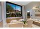 Relaxing sitting room with comfortable armchairs and scenic views of lush greenery and distant mountains at 5905 N Echo Canyon Ln, Phoenix, AZ 85018