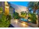 Tranquil water feature with lush landscaping and subtle lighting at 5905 N Echo Canyon Ln, Phoenix, AZ 85018