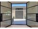 View of a backyard water fountain from inside, seen through black steel doors at 6126 E Charter Oak Rd, Scottsdale, AZ 85254