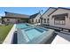Beautiful backyard featuring a pool, jacuzzi, and a modern-style home with a well manicured lawn at 6126 E Charter Oak Rd, Scottsdale, AZ 85254