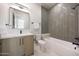 Well-designed bathroom featuring modern fixtures, including a shower/tub combo and sleek vanity at 6126 E Charter Oak Rd, Scottsdale, AZ 85254