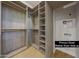 Spacious walk-in closet with custom shelving and washer dryer hook up offers ample storage at 6126 E Charter Oak Rd, Scottsdale, AZ 85254