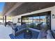Relaxing covered patio with a spacious seating area and views of the pool and putting green at 6126 E Charter Oak Rd, Scottsdale, AZ 85254