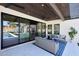 Inviting covered patio featuring comfortable seating, a ceiling fan, and seamless indoor-outdoor living at 6126 E Charter Oak Rd, Scottsdale, AZ 85254