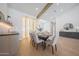 Dining area with wood floors, a wine display, and a modern chandelier at 6126 E Charter Oak Rd, Scottsdale, AZ 85254