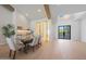 Elegant dining room featuring a wine cellar, wood floors, and contemporary lighting at 6126 E Charter Oak Rd, Scottsdale, AZ 85254