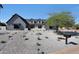 Home exterior boasts a charming walkway to a gray and stone facade at 6126 E Charter Oak Rd, Scottsdale, AZ 85254