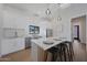 Bright kitchen features an island with seating, modern cabinets, stainless steel appliances, and hardwood floors at 6126 E Charter Oak Rd, Scottsdale, AZ 85254