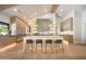 Bright kitchen showcasing custom cabinetry, a central island with seating, and stainless steel refrigerator at 6126 E Charter Oak Rd, Scottsdale, AZ 85254