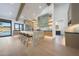 Stylish kitchen featuring a large island with seating, sleek cabinetry, and a view to the pool at 6126 E Charter Oak Rd, Scottsdale, AZ 85254