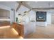 Open kitchen with a large island, stainless steel appliances, and modern lighting at 6126 E Charter Oak Rd, Scottsdale, AZ 85254