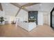 Open-concept living room with wood floors, vaulted ceilings, and a view into the dining area at 6126 E Charter Oak Rd, Scottsdale, AZ 85254