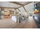 Spacious living area featuring wood floors, beamed ceilings, and seamless access to the kitchen at 6126 E Charter Oak Rd, Scottsdale, AZ 85254
