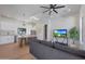 Open-concept living space with modern furnishings, hardwood floors, and a view into the kitchen at 6126 E Charter Oak Rd, Scottsdale, AZ 85254