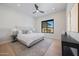 Comfortable main bedroom with neutral decor, ceiling fan, and view of the backyard at 6126 E Charter Oak Rd, Scottsdale, AZ 85254