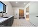 Mud room features granite countertops, dark cabinets, decorative floor tiles and a bench at 6126 E Charter Oak Rd, Scottsdale, AZ 85254