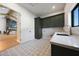 Mud room with granite countertops, dark green cabinets and decorative floor tiles at 6126 E Charter Oak Rd, Scottsdale, AZ 85254
