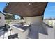 This outdoor kitchen space includes an island with a gas fire pit, seating, and a covered patio at 6126 E Charter Oak Rd, Scottsdale, AZ 85254