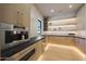 Walk-in pantry with custom shelving, ample storage, and modern lighting at 6126 E Charter Oak Rd, Scottsdale, AZ 85254