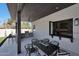 Outdoor patio area with built-in grill and bar, ideal for entertaining, next to the kitchen pass-through window at 6126 E Charter Oak Rd, Scottsdale, AZ 85254