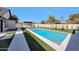 Beautiful pool area with green grass, a spa and white tile at 6126 E Charter Oak Rd, Scottsdale, AZ 85254