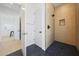 Contemporary shower with unique textured walls and matte black hardware at 6126 E Charter Oak Rd, Scottsdale, AZ 85254