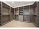Spacious walk-in closet with multiple shelves and racks for optimal storage at 6126 E Charter Oak Rd, Scottsdale, AZ 85254