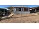 Exterior shot of a single story home featuring a fenced yard, covered porch, and mature landscaping at 614 W 12Th St, Casa Grande, AZ 85122