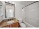 Bathroom with wood vanity, granite countertop, framed mirror, and shower with a tub at 6309 W Hughes Dr, Phoenix, AZ 85043