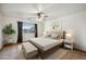 This bedroom features a neutral color palette, tile floors, and a ceiling fan at 6309 W Hughes Dr, Phoenix, AZ 85043