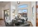 Dining area with a view of the pool, showcasing a table setting, natural light, and desert landscaping at 6309 W Hughes Dr, Phoenix, AZ 85043
