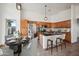 Well-equipped kitchen with stainless steel appliances, wood cabinetry, island seating, and open layout at 6309 W Hughes Dr, Phoenix, AZ 85043