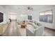 Inviting living room showcasing neutral tones, tile floors, large windows, and comfortable seating at 6309 W Hughes Dr, Phoenix, AZ 85043
