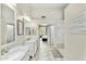 Well-lit bathroom with dual vanities, tiled flooring, and views towards the main bedroom at 6713 E Paradise Ln, Scottsdale, AZ 85254