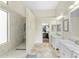Elegant bathroom features a tiled shower, double marble vanities, and access to the walk-in closet at 6713 E Paradise Ln, Scottsdale, AZ 85254