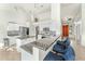 Bright kitchen with white cabinets, granite countertops, stainless steel appliances, and breakfast bar seating at 6713 E Paradise Ln, Scottsdale, AZ 85254