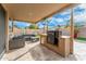 Inviting covered patio with built-in grill and comfortable seating, perfect for outdoor entertaining and dining at 6713 E Paradise Ln, Scottsdale, AZ 85254