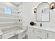 Modern bathroom featuring a glass enclosed shower with decorative tile, vanity, and black and white patterned floor at 7001 E Joan De Arc Ave, Scottsdale, AZ 85254