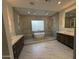 Luxurious Primary bathroom with freestanding tub, walk-in glass shower, and dual vanities at 7001 E Joan De Arc Ave, Scottsdale, AZ 85254