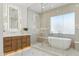 Bathroom featuring modern fixtures, a soaking tub, and a glass-enclosed shower at 7001 E Joan De Arc Ave, Scottsdale, AZ 85254
