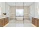 Spa-like bathroom featuring a glass-enclosed shower, soaking tub, and dual vanities at 7001 E Joan De Arc Ave, Scottsdale, AZ 85254