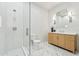Bright bathroom featuring a wooden vanity, glass-enclosed shower, and large marble floor tiles at 7001 E Joan De Arc Ave, Scottsdale, AZ 85254