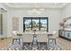 Bright dining area showcasing a sleek table setting and view to the front yard through a large window at 7001 E Joan De Arc Ave, Scottsdale, AZ 85254
