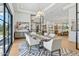 Elegant dining room featuring modern light fixture, stylish rug, and seamless transition to the living space at 7001 E Joan De Arc Ave, Scottsdale, AZ 85254