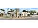 Stunning modern exterior features white brick, black awnings, desert landscaping, and palm trees at 7001 E Joan De Arc Ave, Scottsdale, AZ 85254