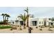 Modern home with white brick, desert landscaping, black awnings, and striking palm trees at 7001 E Joan De Arc Ave, Scottsdale, AZ 85254